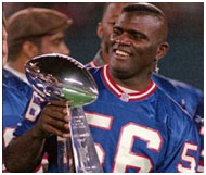 Lawrence Taylor holding the superbowl trophy